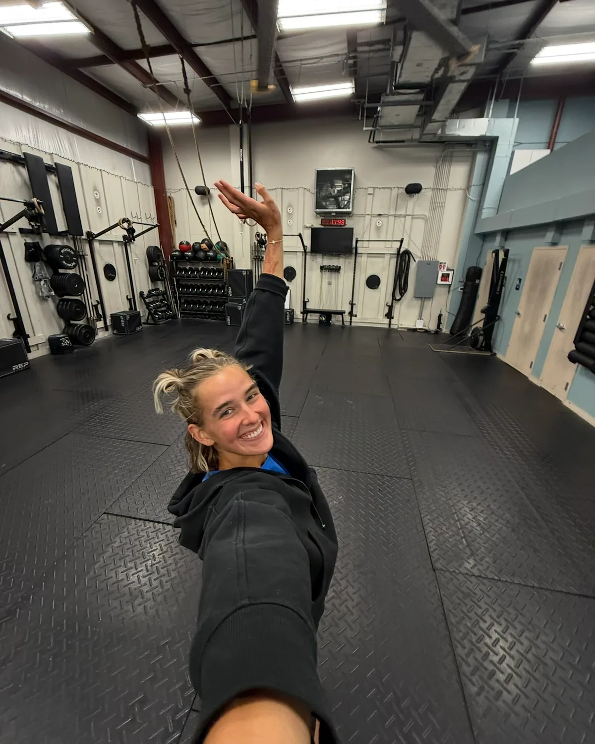 Brooklyne smiling, taking a selfie in the gym