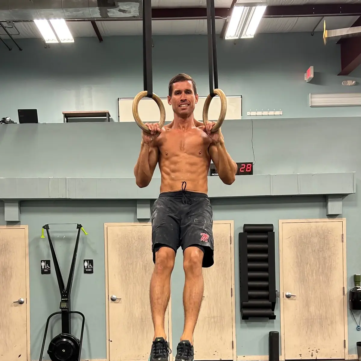 Michael holding an L-sit on the rings